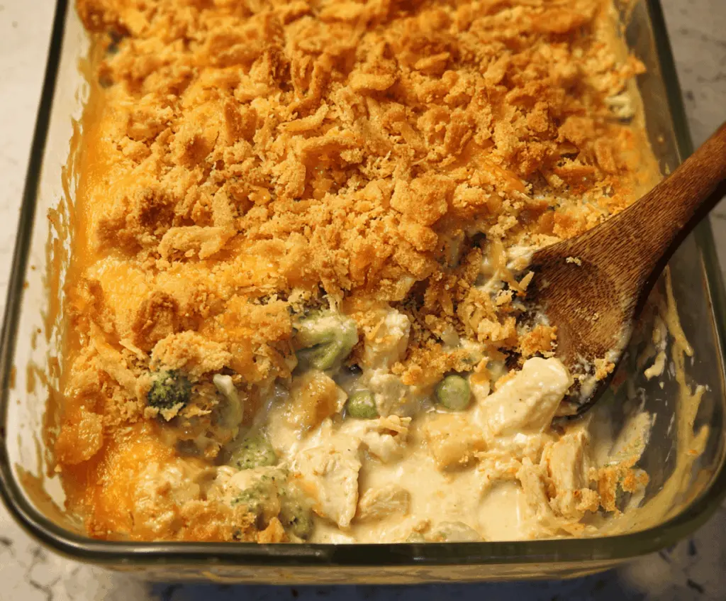 Delicious Chicken Divan casserole with creamy cheese and tender chicken layered in a baking dish.