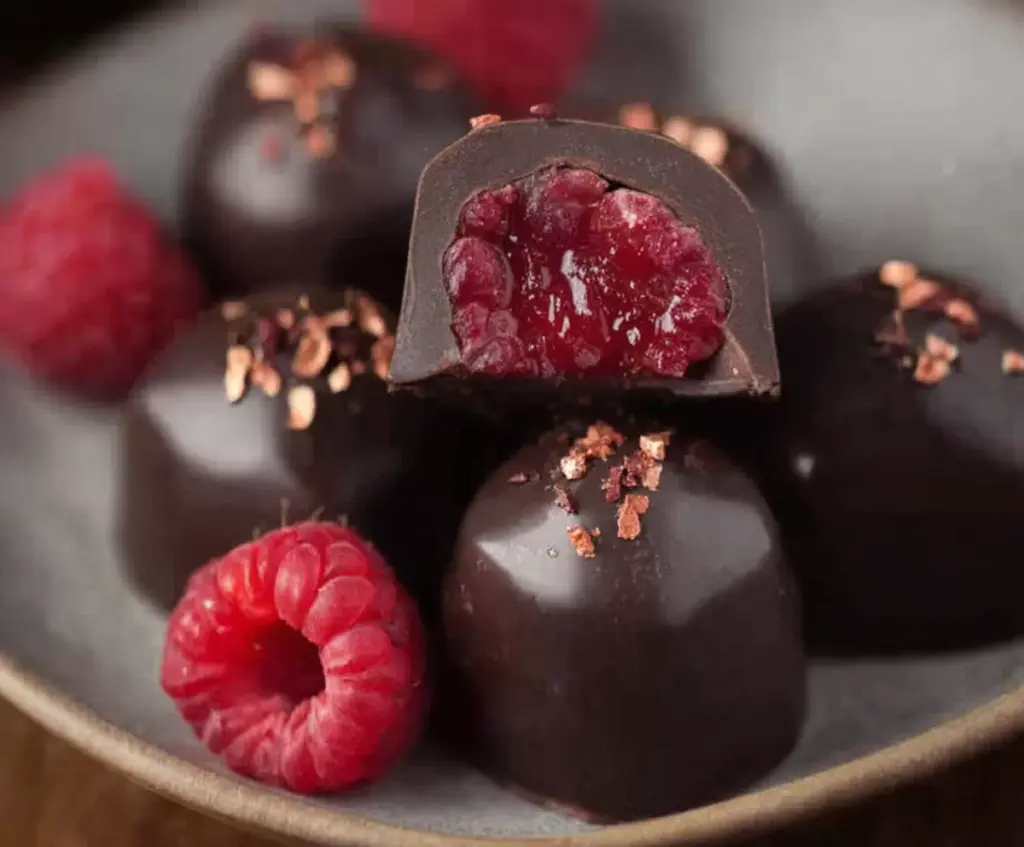 Delicious homemade raspberry chocolates with rich dark chocolate and fresh raspberry filling