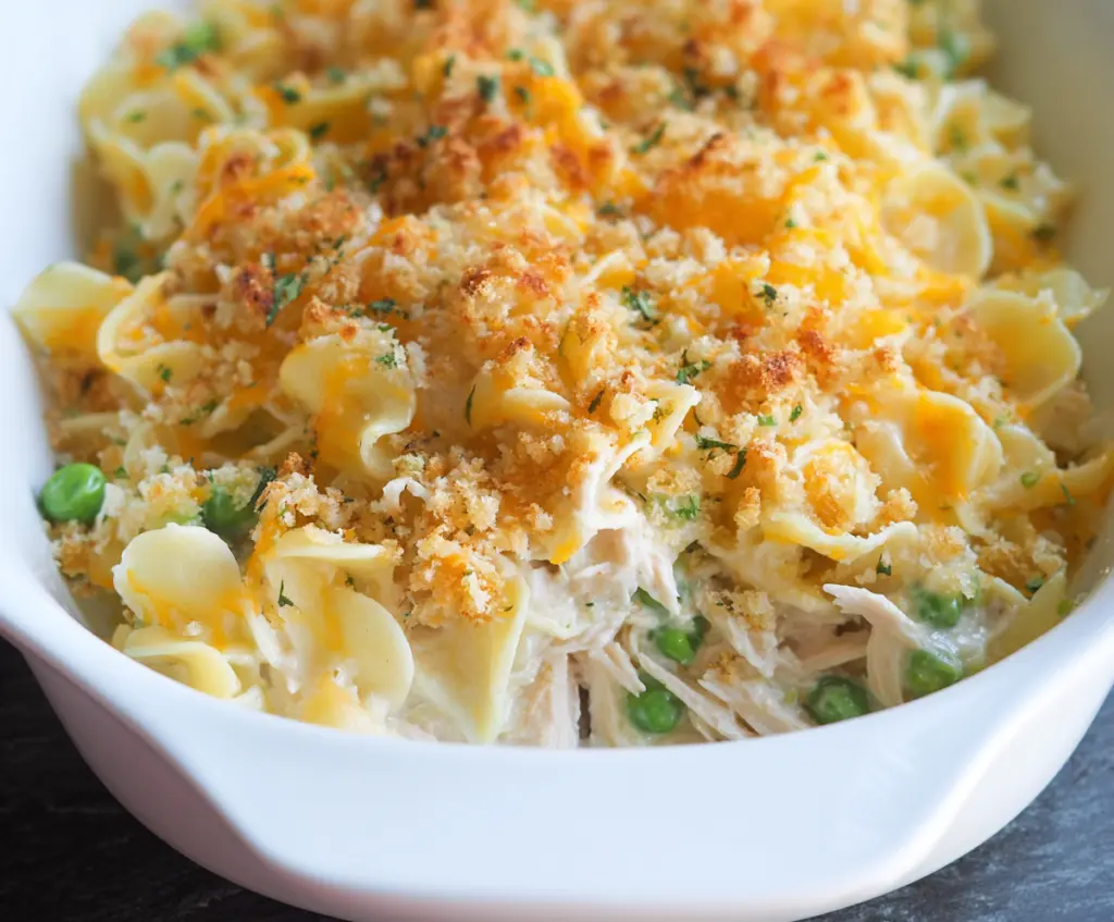 Creamy tuna noodle casserole in a baking dish with golden top, perfect comfort food for dinner.